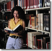 woman reading book, library, bookshelf