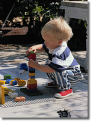 infant playing with blocks